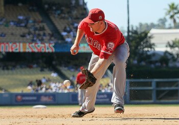 LOS ANGELES, CA - JUNE 25:  First baseman Mark Trumbo #44 of the Los Angeles Angels of Anaheim fields a ground ball by Andre Ethier (not pictured) of the Los Angeles Dodgers in the ninth inning at Dodger Stadium on June 25, 2011 in Los Angeles, California
