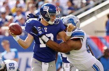 EAST RUTHERFORD, NJ - OCTOBER 17:  Eli Manning #10 of the New York Giants is sacked by Ndamukong Suh #90 of the Detroit Lions at New Meadowlands Stadium on October 17, 2010 in East Rutherford, New Jersey.  (Photo by Nick Laham/Getty Images)