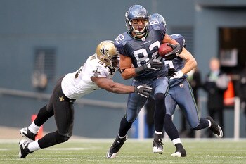 SEATTLE, WA - JANUARY 08:  Ruvell Martin #82 of the Seattle Seahawks makes a move to avoid a tackle by Jonathan Vilma #51 of the New Orleans Saints in the second quarter during the 2011 NFC wild-card playoff game at Qwest Field on January 8, 2011 in Seatt