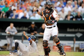 BALTIMORE, MD - JUNE 04:  Matt Wieters #32 of the Baltimore Orioles forces out Corey Patterson #16 of the Toronto Blue Jays and throws to first base for a double play in the third inning at Oriole Park at Camden Yards on June 4, 2011 in Baltimore, Marylan