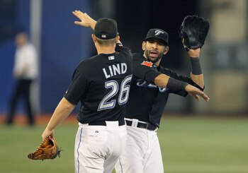 TORONTO, CANADA - JULY 29:  Jose Bautista #19 and Adam Lind #26 of the Toronto Blue Jays celebrate the victory against the Texas Rangers in a MLB game on July 29, 2011 at the Rogers Centre in Toronto, Ontario, Canada. The Blue Jays defeated the Rangers 3-