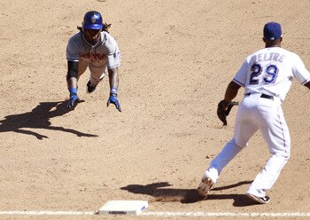 ARLINGTON, TX - JUNE 26: Jose Reyes #7 of the New York Mets dive for third base against the Adrian Beltre #29 of the Texas Rangers at Rangers Ballpark in Arlington on June 26, 2011 in Arlington, Texas.  (Photo by Rick Yeatts/Getty Images)