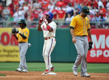 PHILADELPHIA - JUNE 26: Jimmy Rollins #11 of the Philadelphia Phillies (center) reacts after hitting a double in the bottom of the second inning against the Oakland Athletics at Citizens Bank Park on June 26, 2011 in Philadelphia, Pennsylvania. (Photo by