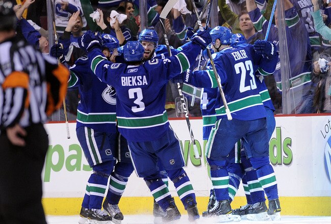 VANCOUVER, BC - MAY 24:  (L-R) Daniel Sedin #22, Kevin Bieksa #3, Ryan Kesler #17 and Alexander Edler #23 of the Vancouver Canucks celebrate Kesler's game-tying goal at 2-2 with less than 14 seconds in the third period to send the game into overtime in Ga