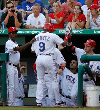 ARLINGTON, TX - JULY 25:  Endy Chavez #9 of the Texas Rangers celerates with manager Ron Washington #38 and Josh Hamilton #32 of the Texas Rangers after scoring against the Minnesota Twins at Rangers Ballpark in Arlington on July 25, 2011 in Arlington, Te