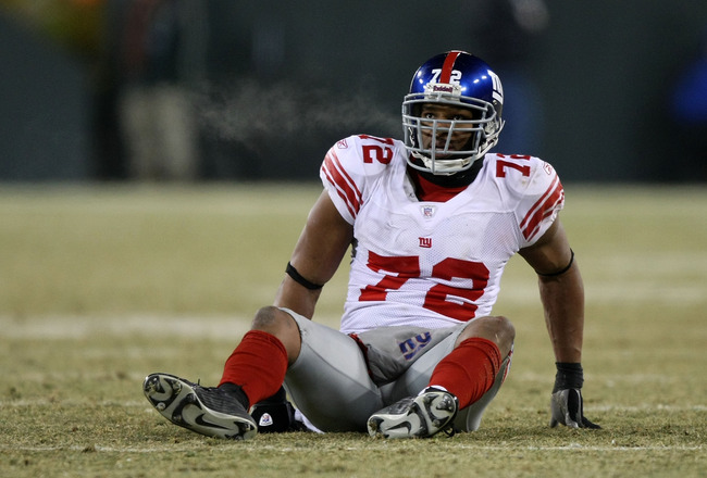 GREEN BAY, WI - JANUARY 20:  Defensive end Osi Umenyiora #72 of the New York Giants sits on the turf during the NFC championship game against the Green Bay Packers on January 20, 2008 at Lambeau Field in Green Bay, Wisconsin.  (Photo by Jed Jacobsohn/Gett