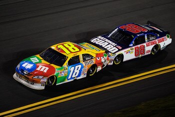 DAYTONA BEACH, FL - FEBRUARY 12:  Kyle Busch, driver of the #18 M&M's Toyota, leads Dale Earnhardt Jr., driver of the #88 National Guard/AMP Energy Chevrolet, during the NASCAR Budweiser Shootout at Daytona International Speedway on February 12, 2011 in D