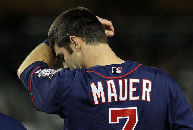 NEW YORK - OCTOBER 09:  Joe Mauer #7 of the Minnesota Twins wipes his forehead against the New York Yankees during Game Three of the ALDS part of the 2010 MLB Playoffs at Yankee Stadium on October 9, 2010 in the Bronx borough of New York City.  (Photo by