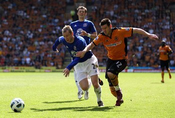WOLVERHAMPTON, ENGLAND - APRIL 09:  Tony Hibbert of Everton holds off Matt Jarvis of Wolves during the Barclays Premier League match between Wolverhampton Wanderers and Everton at Molineux on April 9, 2011 in Wolverhampton, England.  (Photo by Richard Hea