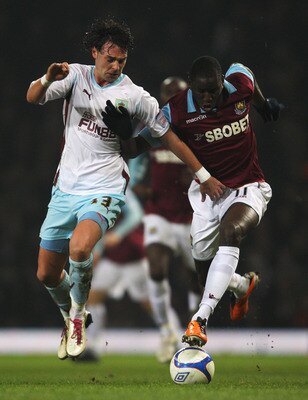 LONDON, ENGLAND - FEBRUARY 21: Chris Eagles of Burnley challenges Demba Ba of West Ham United during the FA Cup sponsored by E.ON 5th Round match between West Ham United and Burnley at the Boleyn Ground on February 21, 2011 in London, England.  (Photo by