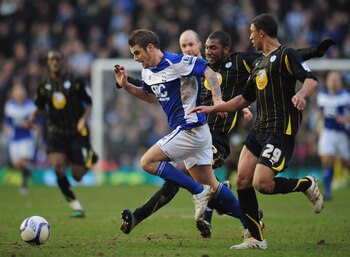 BIRMINGHAM, ENGLAND - FEBRUARY 19:  David Bentley of Birmingham City is challenged by Reda Johnson (22) and Liam Palmer (29) of Sheffield Wednesday during the FA Cup Sponsored by e.on 5th Round match between Birmingham City and Sheffield Wednesday at St A