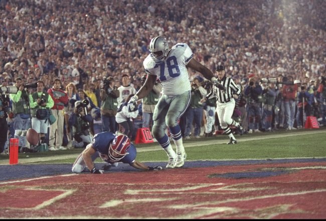 31 Jan 1993: Wide receiver Don Beebe of the Buffalo Bills (left) forces a fumble on defensive tackle Leon Lett of the Dallas Cowboys during Super Bowl XXVII at the Rose Bowl in Pasadena, California. The Cowboys won the game, 52-17.