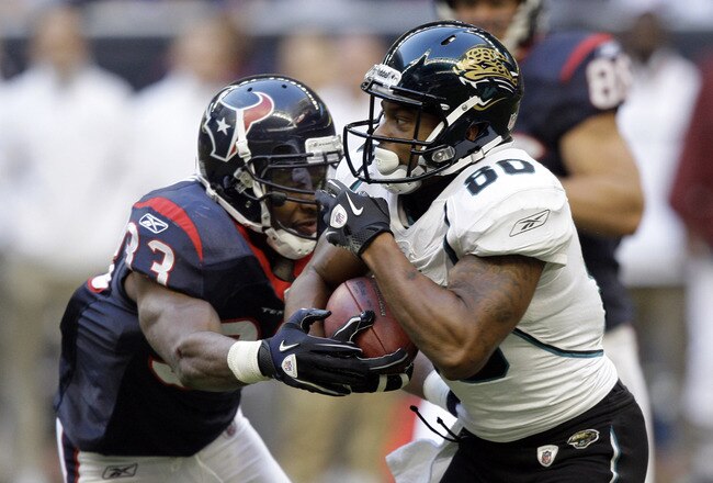 HOUSTON - JANUARY 02:  Wide receiver Mike Thomas #80 of the Jacksonville Jaguars is tackled by Troy Nolan #33 of the Houston Texans at Reliant Stadium on January 2, 2011 in Houston, Texas.  (Photo by Bob Levey/Getty Images)