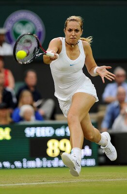 LONDON, ENGLAND - JUNE 23:  Sabine Lisicki of Germany returns a shot during her second round match against Na Li of China on Day Four of the Wimbledon Lawn Tennis Championships at the All England Lawn Tennis and Croquet Club on June 23, 2011 in London, En