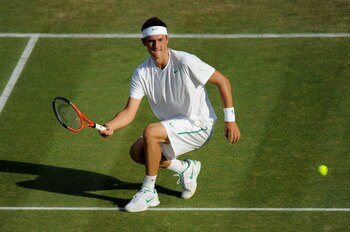 LONDON, ENGLAND - JUNE 25:  Bernard Tomic of Australia returns a shot during his third round match against Robin Soderling of Sweden on Day Six of the Wimbledon Lawn Tennis Championships at the All England Lawn Tennis and Croquet Club on June 25, 2011 in 