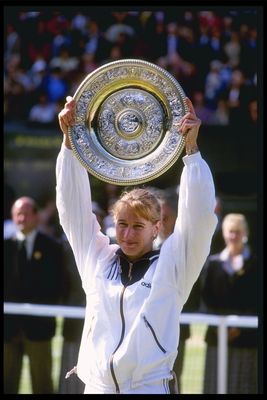6 Jul 1996:  Steffi Graf of Germany once again lifts the womens singles trophy after her straight sets victory over Arantxa Sanchez Vicario of Spain during the Wimbledon tennis championships at the all England Club in London, England.Mandatory Credit: Cli