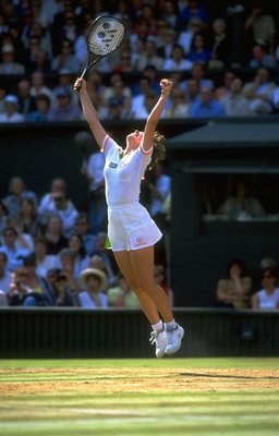 5 Jul 1997:  Martina Hingis of Switzerland raises her arms aloft and jumps for joy as she wins the Women's Singles final against Jana Novotna of the Czech Republic during the Lawn Tennis Championships at Wimbledon in London. Hingis won the match in threes