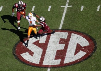 COLUMBIA, SC - OCTOBER 30:  Tyler Bray #8 of the Tennessee Volunteers chased by teammates Stephon Gilmore #5 and Cliff Matthews #83 of the South Carolina Gamecocks during their game at Williams-Brice Stadium on October 30, 2010 in Columbia, South Carolina