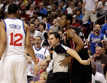 PHILADELPHIA, PA - APRIL 24: Official David Guthrie (C) seperates Evan Turner #12 of the Philadelphia 76ers and James Jones #22 of the Miami Heat (R) after an altercation during the first half of Game Four of the Eastern Conference Quarterfinals at Wells