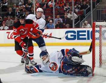 NEWARK, NJ - MARCH 30: Nick Palmieri #32 of the New Jersey Devils and Rick DiPietro #39 of the New York Islanders keep an eye on the puck at the Prudential Center on March 30, 2011 in Newark, New Jersey.  (Photo by Bruce Bennett/Getty Images)