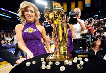 LOS ANGELES, CA - OCTOBER 27:  A member of the Laker Girls poses with the Larry O'Brien championship trophy and rings to be presented to the Los Angeles Lakers before the season opening game against the Los Angeles Clippers at Staples Center on October 27