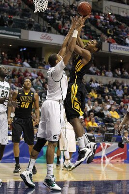 INDIANAPOLIS, IN - MARCH 10:  Melsahn Basabe #1 of the Iowa Hawkeyes attempts a shot against Adreian Payne #5 of the Michigan State Spartans during the first round of the 2011 Big Ten Men's Basketball Tournament at Conseco Fieldhouse on March 10, 2011 in