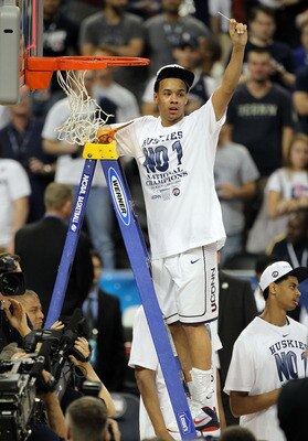 HOUSTON, TX - APRIL 04:  Shabazz Napier #13 of the Connecticut Huskies cuts down the net after defeating the Butler Bulldogs to win the National Championship Game of the 2011 NCAA Division I Men's Basketball Tournament by a score of 53-41 at Reliant Stadi