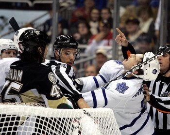 PITTSBURGH, PA - DECEMBER 08:  Colby Armstrong #9 of the Toronto Maple Leafs reacts to being punched by Arron Asham #45 of the Pittsburgh Penguins at Consol Energy Center on December 8, 2010 in Pittsburgh, Pennsylvania.  (Photo by Justin K. Aller/Getty Im