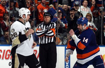 UNIONDALE, NY - APRIL 08:  Eric Godard #28 of the Pittsburgh Penguins fights with Trevor Gillies #14 of the New York Islanders as referee Francois St. Laurent #38 looks on at the Nassau Coliseum on April 8, 2011 in Uniondale, New York.  (Photo by Bruce Be