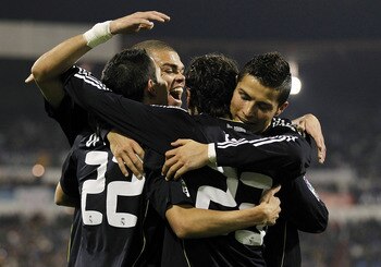 ZARAGOZA, SPAIN - DECEMBER 12:  Mezut Ozil of Real Madrid celebrates with his team mates Cristiano Ronaldo (R), Pepe (C) and Angel di Maria after scoring Real's opening goal during the La Liga match between Real Zaragoza and Real Madrid at La Romareda sta