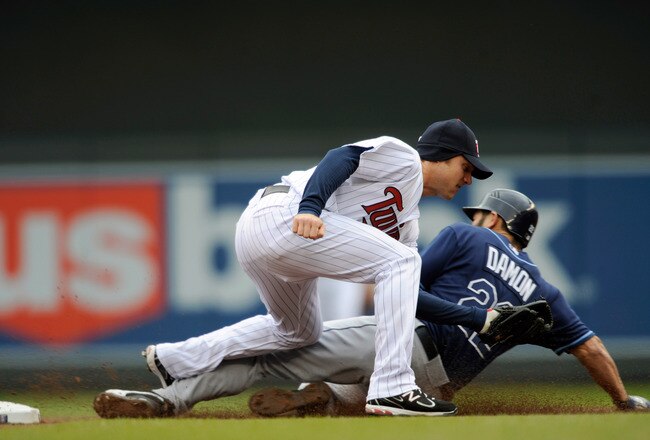 MINNEAPOLIS, MN - APRIL 28: Johnny Damon #22 of the Tampa Bay Rays slides in safely to second base as Luke Hughes #38 of the Minnesota Twins defends second base during in the first inning of their game on April 28, 2011 at Target Field in Minneapolis, Min