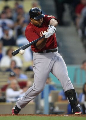 LOS ANGELES, CA - JUNE 17:  Carlos Lee #45 of the Houston Astros hits a single in the top of the fourth inning during the MLB game against the Los Angeles Dodgers at Dodger Stadium on June 17, 2011 in Los Angeles, California.  (Photo by Victor Decolongon/