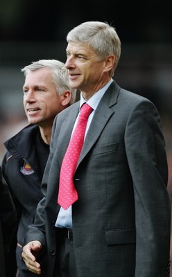 LONDON - NOVEMBER 05:  Alan Pardew (L) the West Ham United manager, and Arsene Wenger (R) the Arsenal manager watch from the touchline during the Barclays Premiership match between West Ham United and Arsenal at Upton Park on November 5, 2006 in London, E