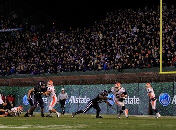 CHICAGO, IL - NOVEMBER 20: Mikel Leshoure #5 of the Illinois Fighting Illini breaks a tackle attempt by Jared Carpenter #27 of the Northwestern Wildcats on his way to a 330 yard rushing performance during a game played at Wrigley Field on November 20, 201