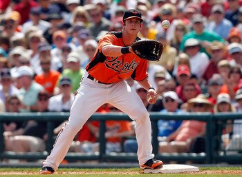 SARASOTA, FL - MARCH 05:  First baseman Joe Mahoney #76 of the Baltimore Orioles takes the throw at first against the Boston Red Sox during a Grapefruit League Spring Training Game at Ed Smith Stadium on March 5, 2011 in Sarasota, Florida.  (Photo by J. M