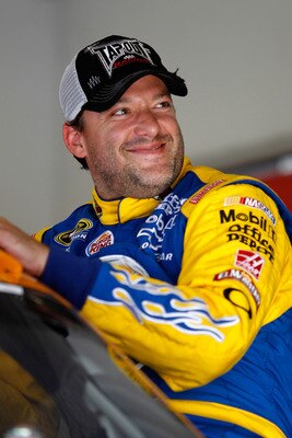 DAYTONA BEACH, FL - JUNE 30:  Tony Stewart, driver of the #14 Burger King Chevrolet, climbs into his car during practice for the NASCAR Sprint Cup Series COKE ZERO 400 Powered by Coca-Cola at Daytona International Speedway on June 30, 2011 in Daytona Beac