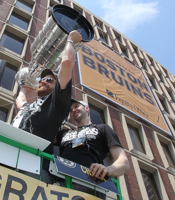 BOSTON, MA  - JUNE 18:Tim Thomas and  Zdeno Chara, both of the Boston Bruins, reacts to cheers a Stanley Cup victory parade on June 18, 2011 in Boston, Massachusetts.  (Photo by Jim Rogash/Getty Images)