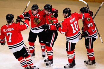 CHICAGO, IL - APRIL 17: (L-R) Brent Seabrook #7, Jonathan Toews #19, Duncan Keith #2, Patrick Sharp #10 and Patrick Kane #88 of the Chicago Blackhawks celebrate Keith's 1st period power-play goal against the Vancouver Canucks in Game Three of the Western