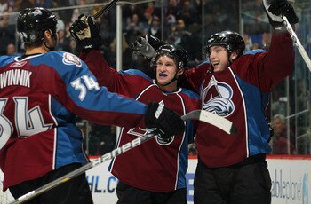 DENVER, CO - MARCH 22:  (R-L) Matt Duchene #9 of the Colorado Avalanche celebrates his third period goal with teammate Mark Oliver #40 and Daniel Winnik #34 to tie the score 3-3 in the third period against the Columbus Blue Jackets at the Pepsi Center on