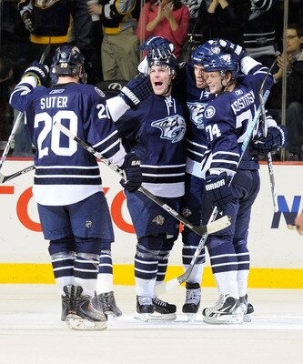 NASHVILLE, TN - FEBRUARY 12:   Ryan Suter #20, Mike Fisher #12, Shea Weber #6, and Sergei Kostitsyn #74 of the Nashville Predators celebrate after a goal against the Colorado Avalanche on February 12, 2011 at the Bridgestone Arena in Nashville, Tennessee.