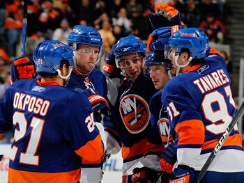 UNIONDALE, NY - MARCH 13:  L-R Kyle Okposo #21, Josh Bailey #12 and Frans Nielsen #51 congratulate teammate Mark Streit #2 along with John Tavares #91 of the New York Islanders as they celebrate a goal by Streit in the second period against the New Jersey