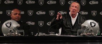 ALAMEDA, CA - JANUARY 18:  New Oakland Raiders coach Hue Jackson (L) looks on as Raiders owner Al Davis speaks during a press conference on January 18, 2011 in Alameda, California. Hue Jackson was introduced as the new coach of the Oakland Raiders, replac