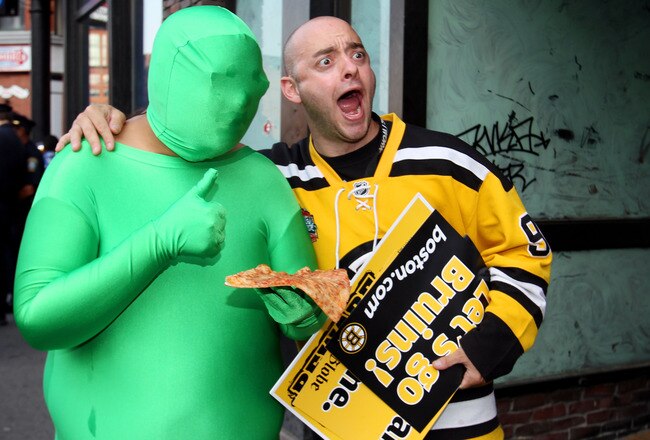 BOSTON, MA - JUNE 08:  A fan of the Boston Bruins poses for a photo with a man in a green suit prior to Game Four of the 2011 NHL Stanley Cup Final between the Vancouver Canucks and the Boston Bruins at TD Garden on June 8, 2011 in Boston, Massachusetts.