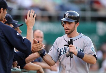OAKLAND, CA - JULY 05:  Dustin Ackley #13 of the Seattle Mariners is congratulated by teammates after he scored in the second inning against the Oakland Athletics at Oakland-Alameda County Coliseum on July 5, 2011 in Oakland, California.  (Photo by Ezra S