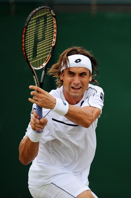 LONDON, ENGLAND - JUNE 27:  David Ferrer of Spain returns a shot during his fourth round match against  Jo-Wilfried Tsonga of France  on Day Seven of the Wimbledon Lawn Tennis Championships at the All England Lawn Tennis and Croquet Club on June 27, 2011