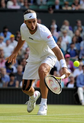 LONDON, ENGLAND - JUNE 29:  Feliciano Lopez of Spain returns a shot during his quarterfinal round match against Andy Murray of Great Britain on Day Nine of the Wimbledon Lawn Tennis Championships at the All England Lawn Tennis and Croquet Club on June 29,