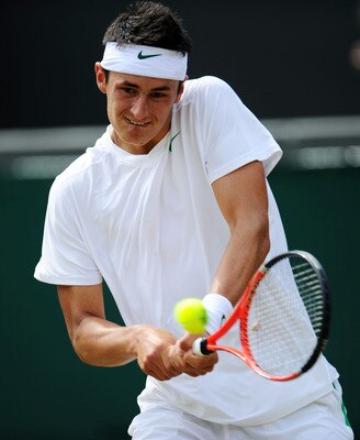 LONDON, ENGLAND - JUNE 29:  Bernard Tomic of Australia returns a shot during his quarterfinal round match against Novak Djokovic of Serbia on Day Nine of the Wimbledon Lawn Tennis Championships at the All England Lawn Tennis and Croquet Club on June 29, 2