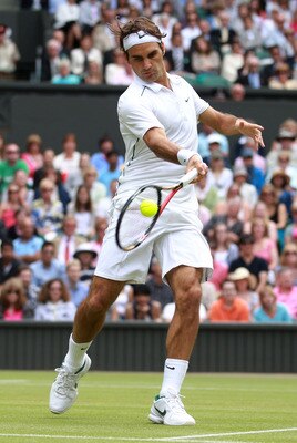 LONDON, ENGLAND - JUNE 29:  Roger Federer of Switzerland returns a shot during his quarterfinal round match against Jo-Wilfried Tsonga of France on Day Nine of the Wimbledon Lawn Tennis Championships at the All England Lawn Tennis and Croquet Club on June