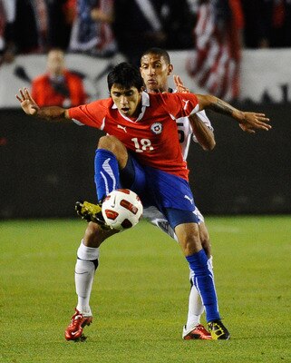 CARSON, CA - JANUARY 22:  Edson Puch #18 of Chile controls the ball against Sean Franklin #15 of the United States during the friendly soccer match at The Home Depot Center on January 22, 2011 in Carson, California.  (Photo by Kevork Djansezian/Getty Imag