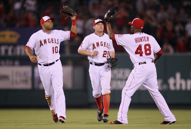 ANAHEIM, CA - JULY 04:  (L-R) Vernon Wells #10, Peter Bourjos #25 and Torii Hunter #48 of the Los Angeles Angels of Anaheim celebrate following their teams victory over the Detroit Tigers at Angel Stadium of Anaheim on July 4, 2011 in Anaheim, California.